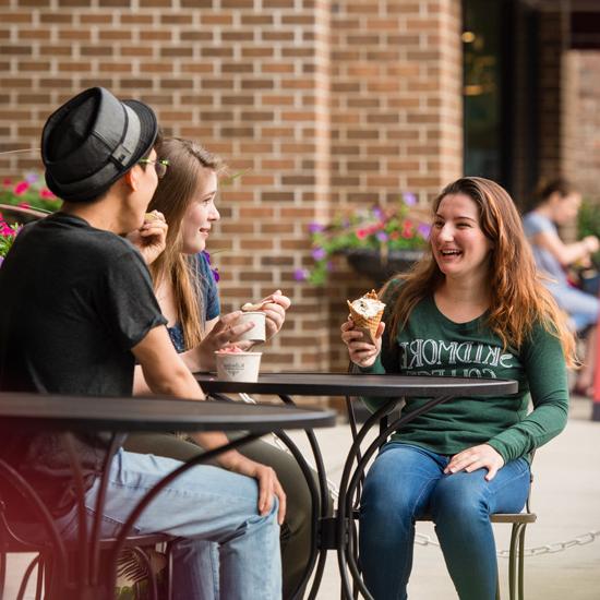 Three students have ice cream in downtown Saratoga Springs